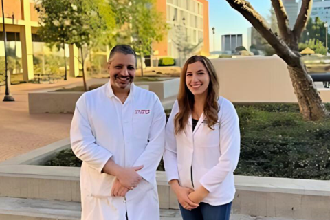 Medical student and her mentor stand outside of a building