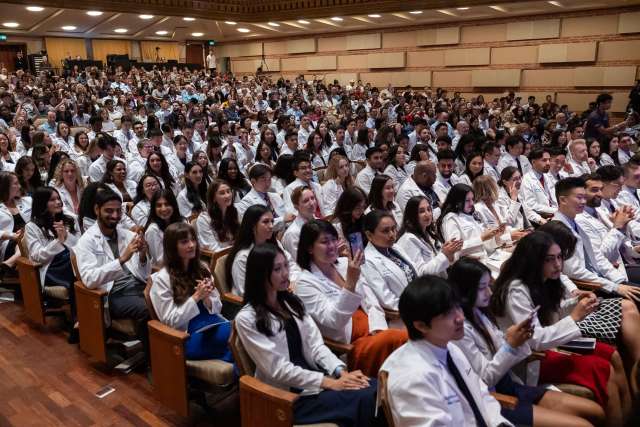 Medical students pack the Royce Hall auditorium for this year's white coat ceremony