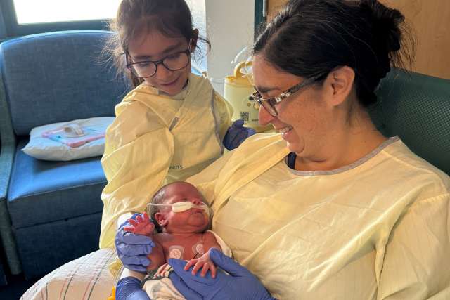 Mom Eliana Cantu and her daughter, Marleen, visit with baby Ian in the NICU. 