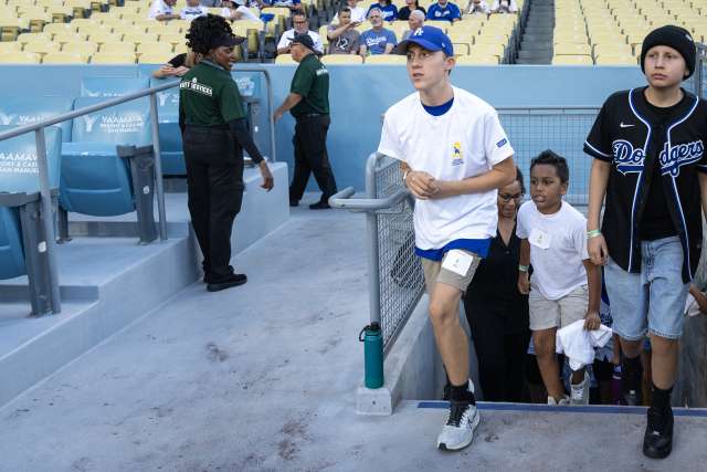 Keaton and other youths walk on to the field at Dodger Stadium