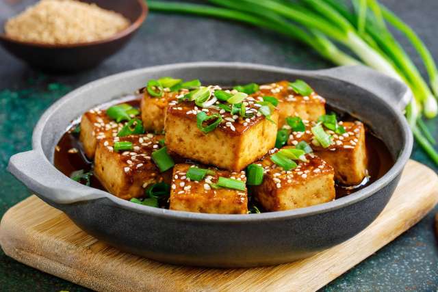 Pan Fried Tofu in Garlic Soy Sesame Sauce in a Skillet
