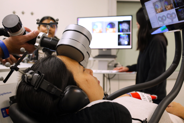A patient takes part in a clinical trial on whether brain stimulation can help treat post-concussion symptoms. (Handout Photo)