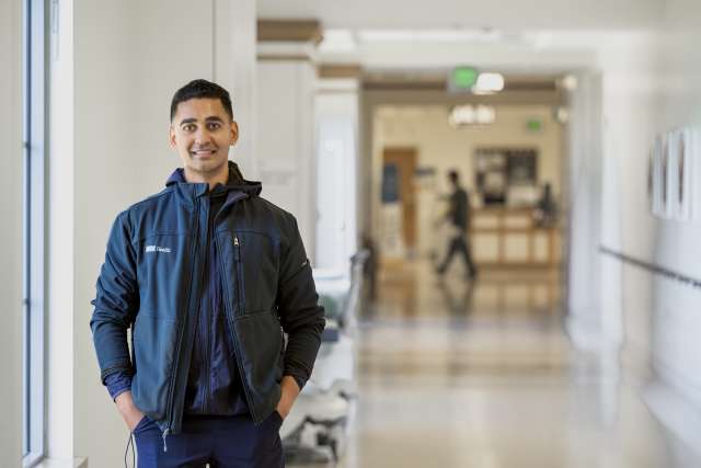 Nurse Mithun Mahinda stands in a hospital hallway.