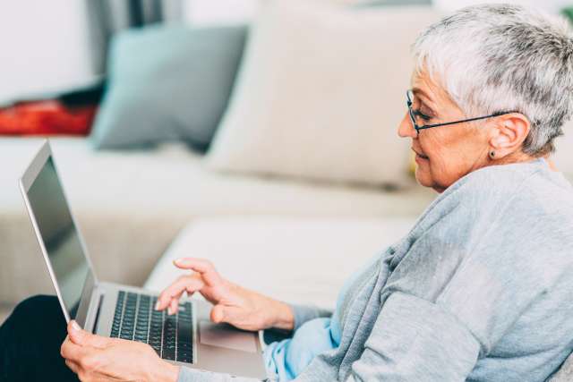 Older woman using laptop computer