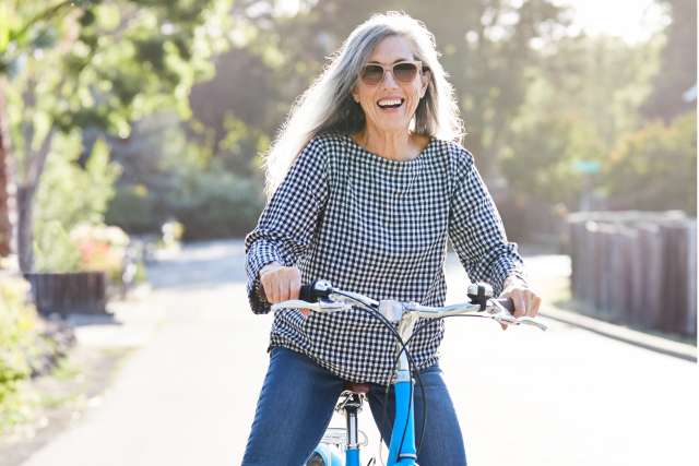 An older woman on a bicycle