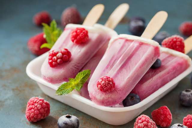 Creamy Berry Homemade Popsicles in a White Dish
