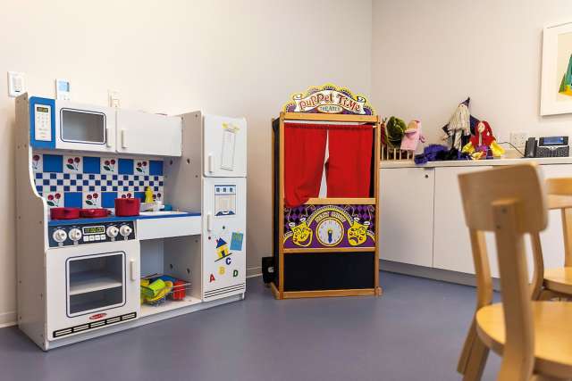 Kids playroom with play kitchen and puppet theater