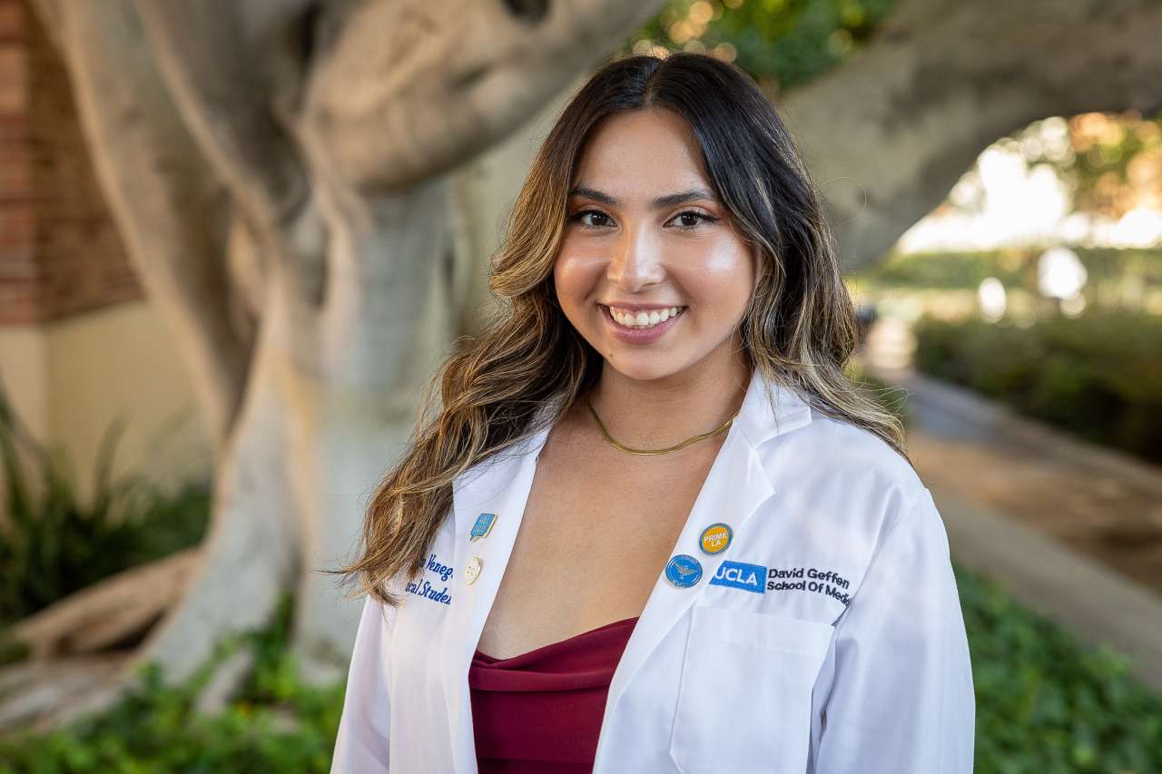 Medical student Erika Venegas poses for a photo in her white coat.