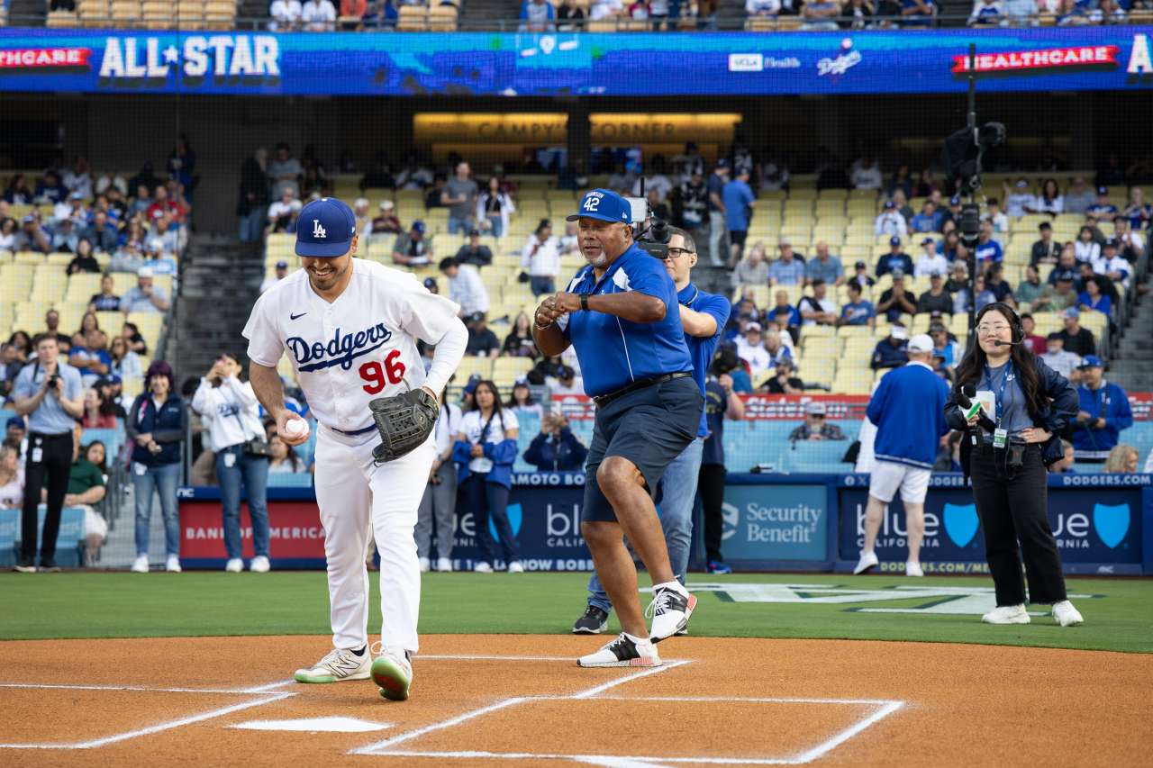 Umpire Rudy Lopez calls a strike at home plate after nurse Lakeysha Pack throws out the first pitch before a Dodgers game.