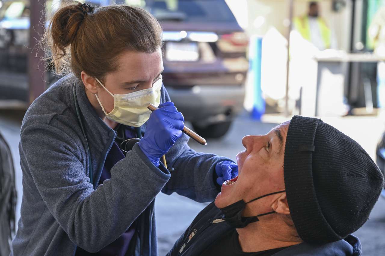 Nurse Kate Gieschen examines the throat of patient Franklin McCutcheon during a shift with the Homeless Healthcare unit. 
