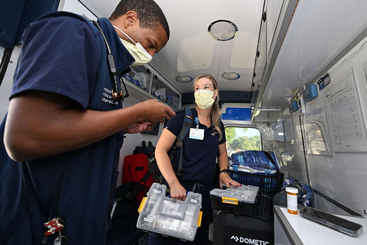 Dr. Phillip Brown works with nurse Zoe McFall inside a Homeless Healthcare Collaborative mobile van. 