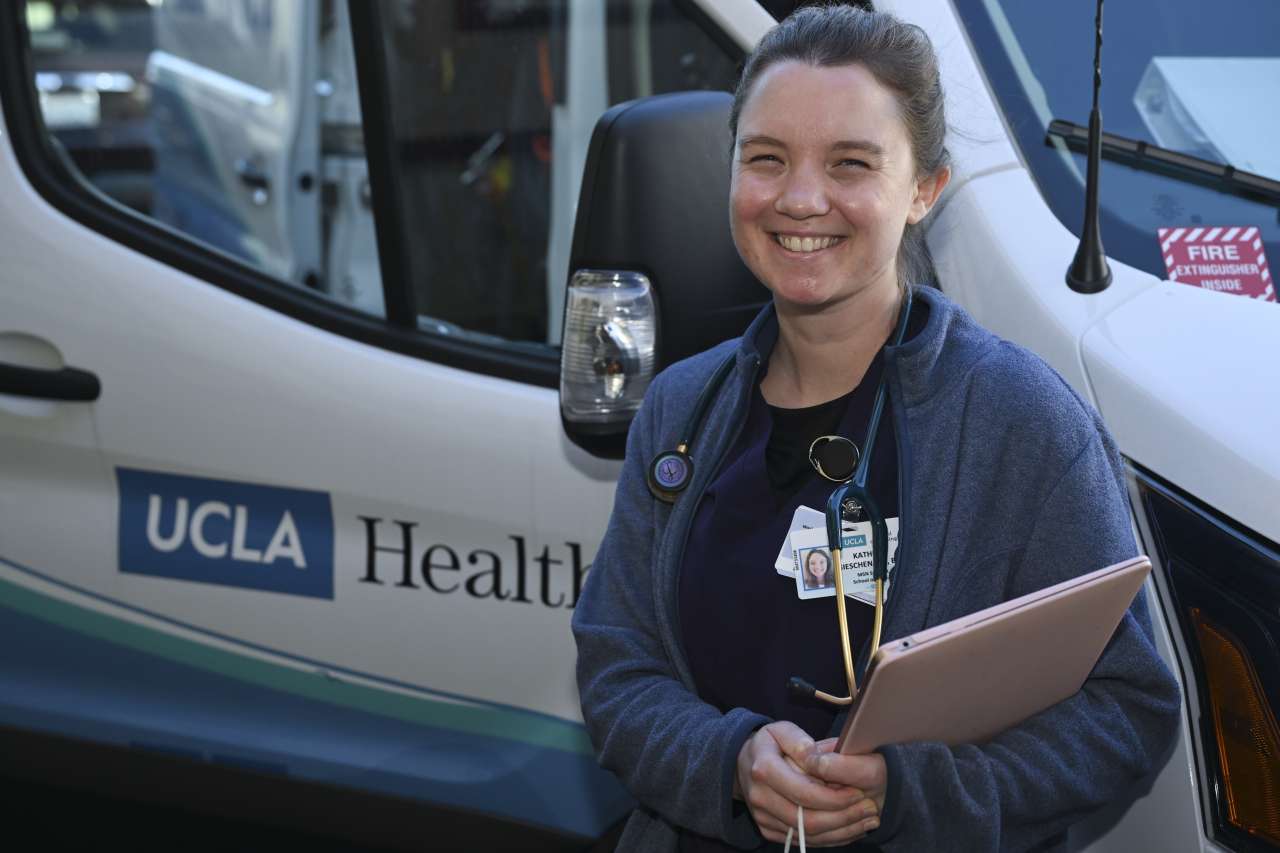 Nurse Kate Gieschen stands outside a Homeless Healthcare Collaborative van. 