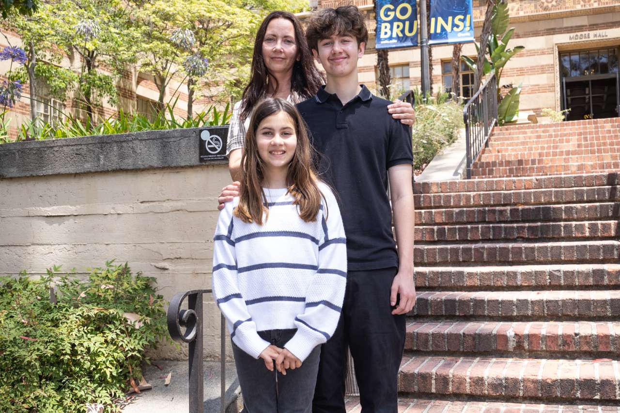 Luka poses for a photo with his mother and sister