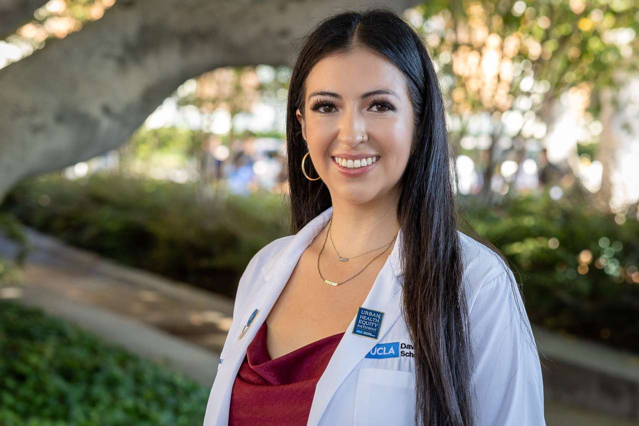 Medical student Andrea Guevara-Castro poses for a photo in her white coat.