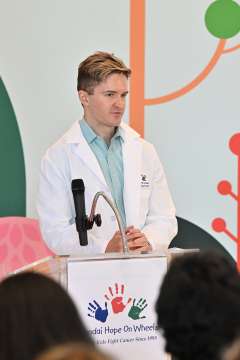 Dr. Theodore Scott Nowicki stands at the podium during the Hope on Wheels event.