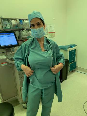 Diana Hekmat, MD wearing Willows (wearable pumps) under scrubs in hospital.
