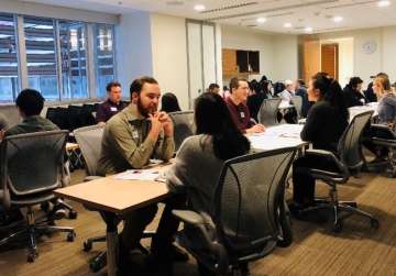 Young adults sitting at conference table