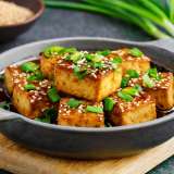 Pan Fried Tofu in Garlic Soy Sesame Sauce in a Skillet