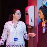 NICU nurse Emily Rogers works with actress Tiffany Villarin on stage.